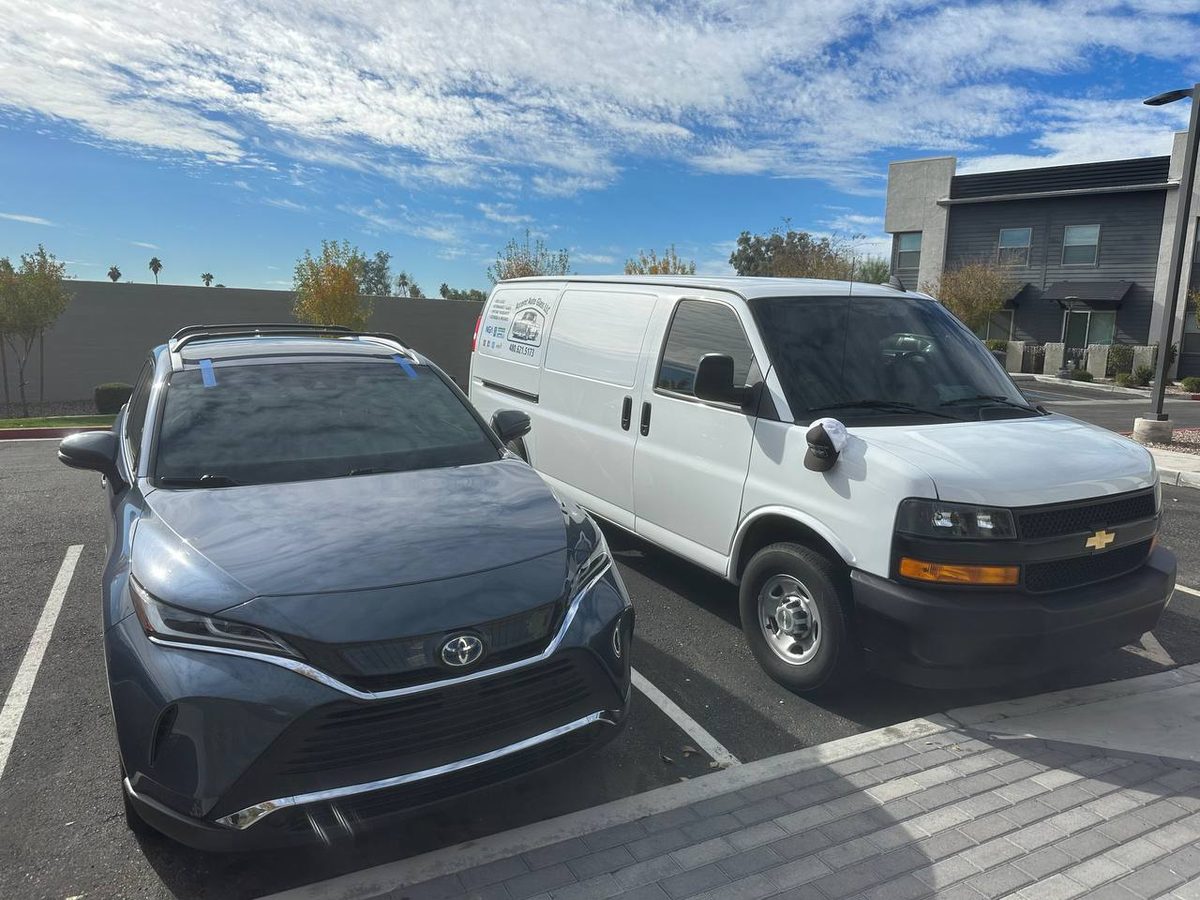 Mobile auto glass install in progress at a customer's home